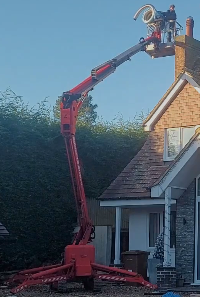Chimney Liner being installed by Danny Iwanejko using his tracked spider cherrypicker in Eakring, Nottinghamshire