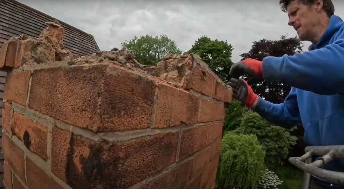 Photo shows Danny Iwanejko AKA Dan the cherrypicker man, removing bricks from a chimney in Wollerton, Nottingham